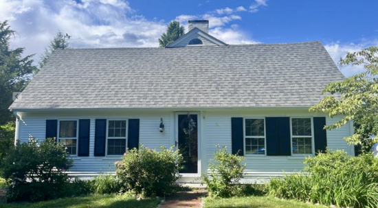 White Cape Cod Style home with Sherwin Williams' Tricorn Black shutters